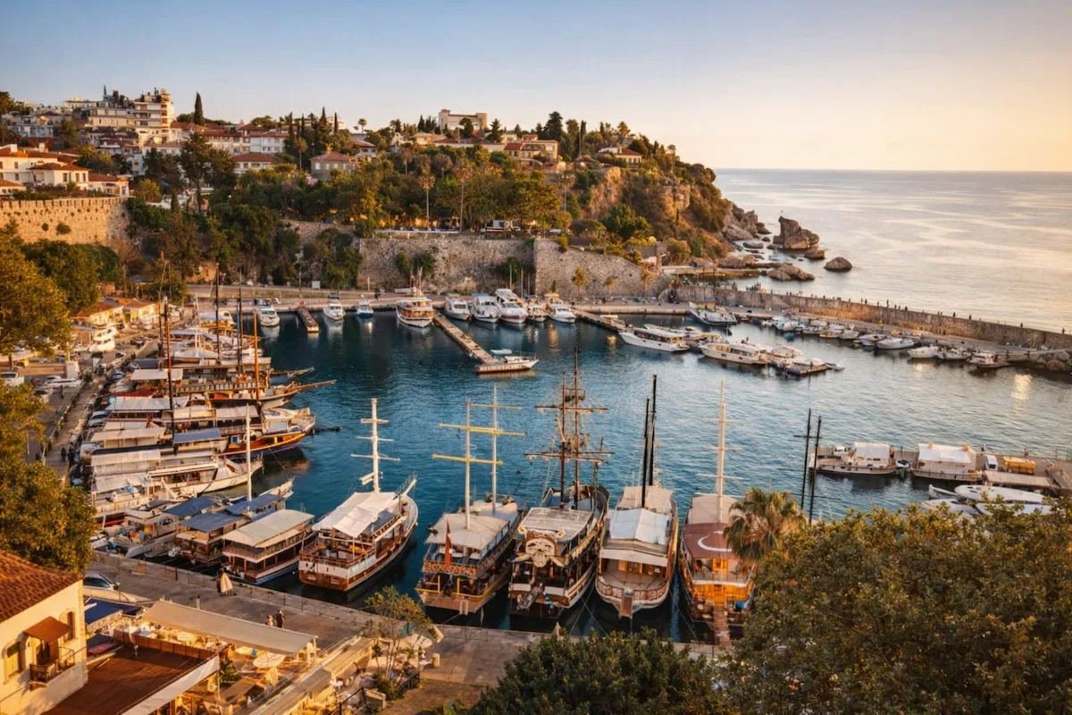 Antalya's old harbour at sunset, lined with traditional wooden boats