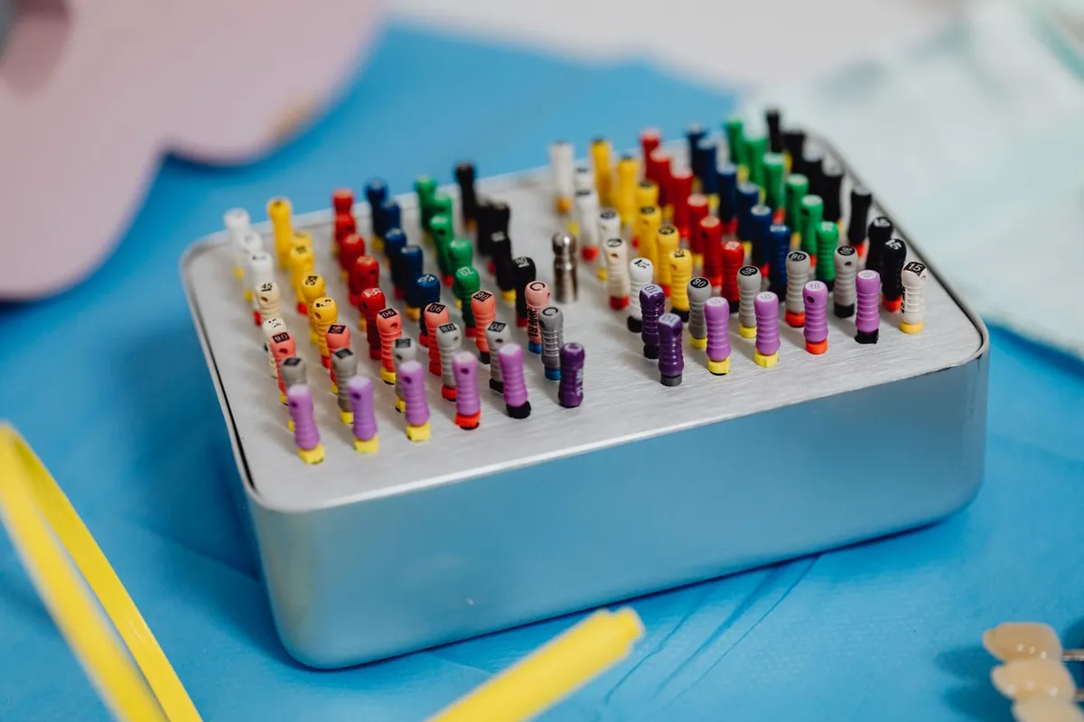 Colour-coded endodontic files arranged in a holder
